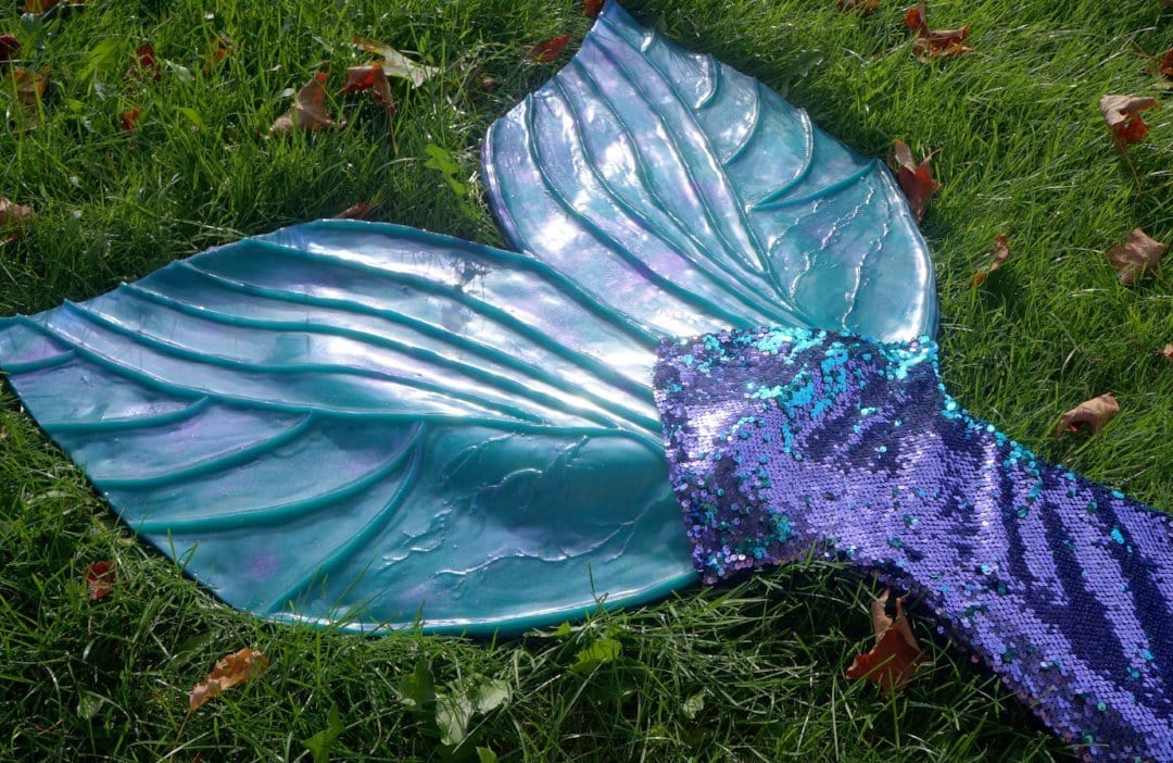 Sequin mermaid tail made with reversible mermaid sequin fabric. Teal blue and purple sequin mermaid tail