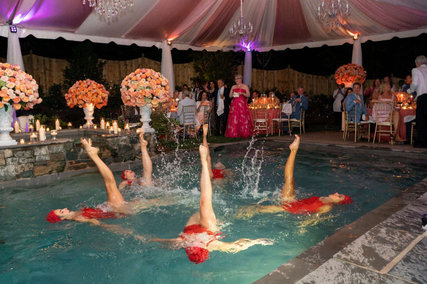 Synchronized swimmers in a dramatic evening formation, ideal for film and commercials